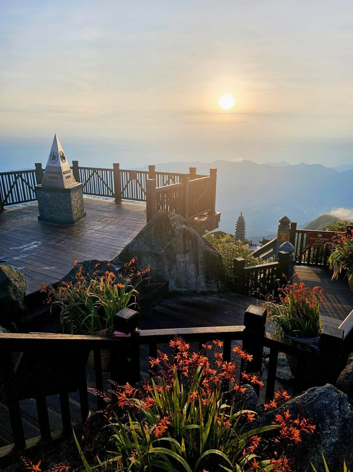 Panoramic view of a Vietnamese city skyline at sunset, featuring historical buildings and modern structures