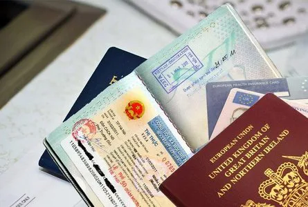 A traveler presenting a passport at an immigration counter in Vietnam
