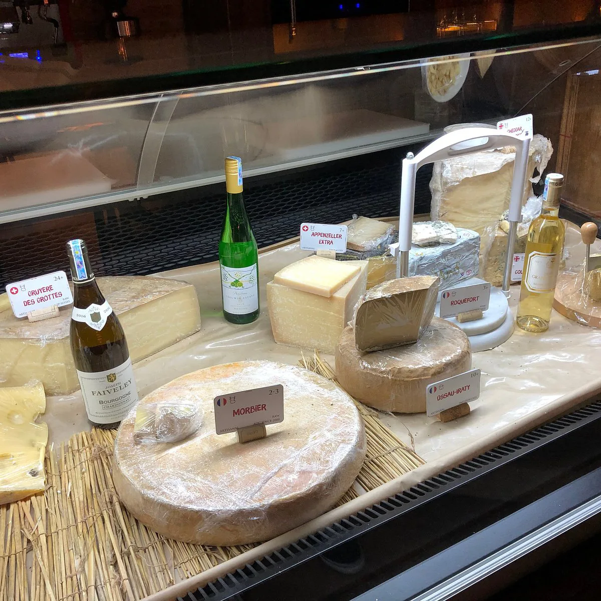Assorted French cheeses and charcuterie on a wooden board