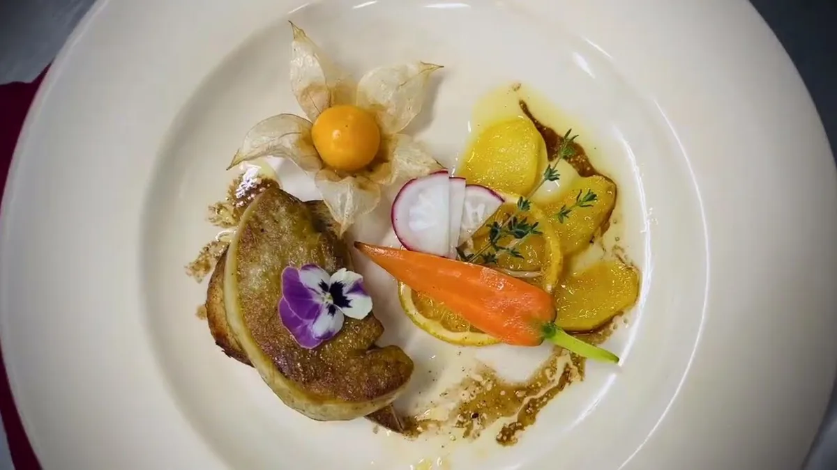 Pan-fried foie gras on a plated garnish