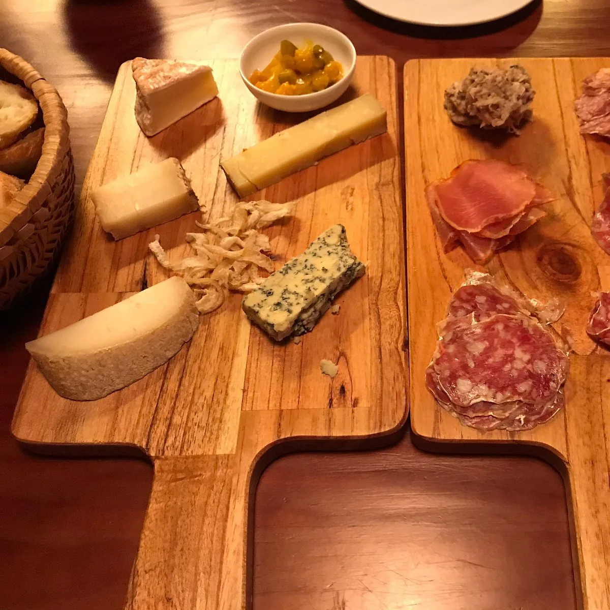 Assorted French cheeses and charcuterie on a wooden board