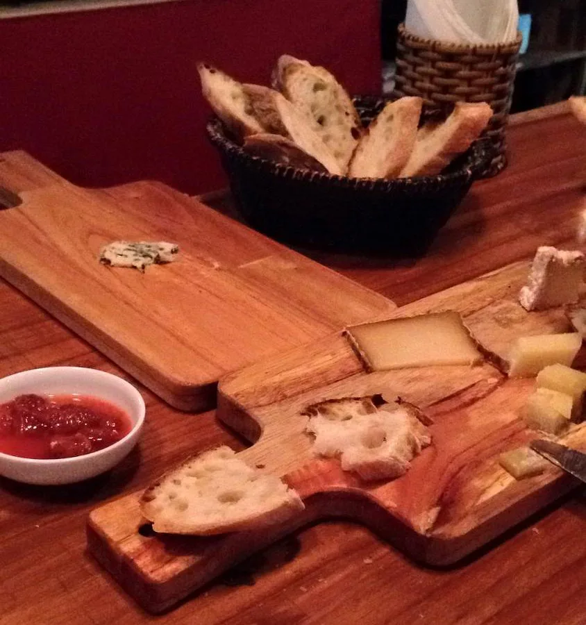 Assorted French cheeses and charcuterie on a wooden board