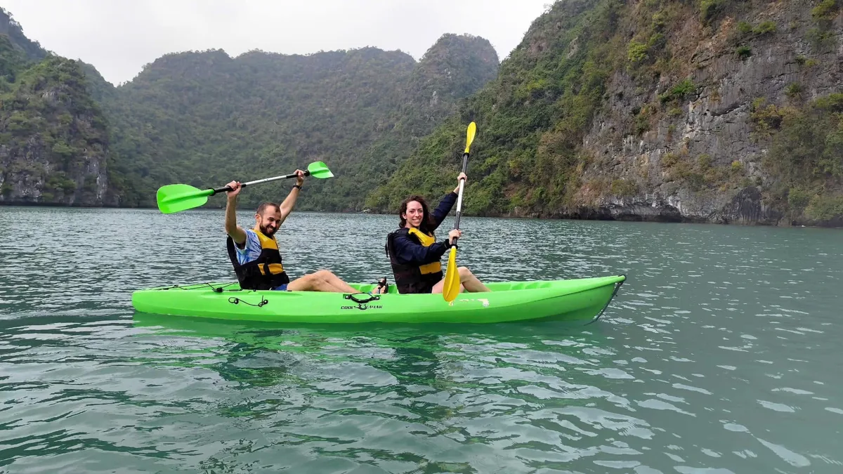 Panoramic view of Halong Bay with limestone karsts and a traditional junk boat